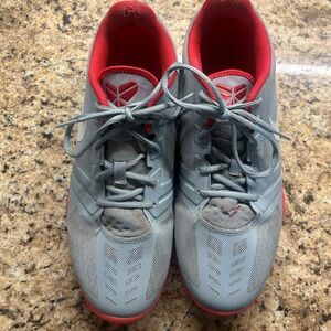 12 Nike Kobe basketball shoes in a sleek gray and neon orange colorway